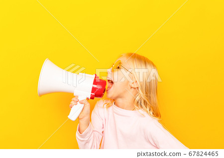 Kid shouting through vintage megaphone. Communication concept. Blue sky background as copy space for your text Kid shouting through vintage megaphone. Communication concept. Blue sky background as copy space for your text 67824465
