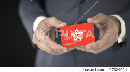 Businessman takes plastic bank card with printed flag of Hong Kong, fictional numbers 67824624