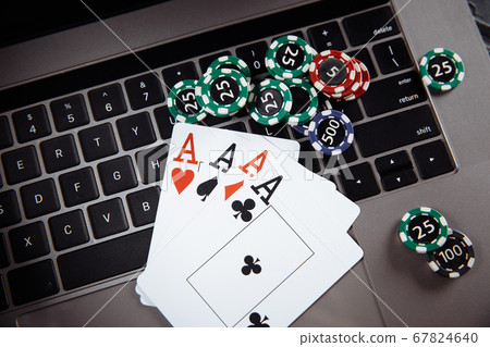 Legal rules for online gambling concept. Wooden gavel, money banknotes and playing cards on laptop keyboard Legal rules for online gambling concept. Wooden gavel, money banknotes and playing cards on laptop keyboard 67824640