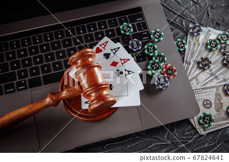 Judge's wooden gavel, poker chips and playing cards. Concept of Law and regulation of gambling 67824641