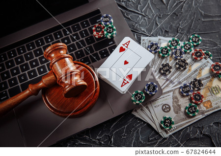 Judge gavel, money banknotes and playing cards on computer keyboard, legal rules for online gambling concept Judge gavel, money banknotes and playing cards on computer keyboard, legal rules for online gambling concept 67824644
