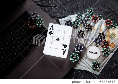 Online casino concept. Gambling chips and playing cards on grey background Online casino concept. Gambling chips and playing cards on grey background 67824647