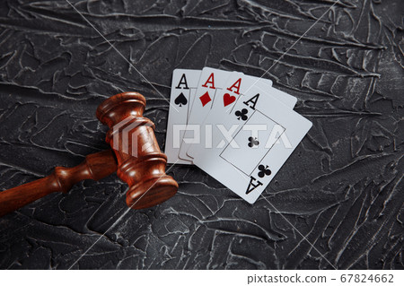Law and rules for online gambling concept, judge gavel with playng cards on grey background Law and rules for online gambling concept, judge gavel with playng cards on grey background 67824662