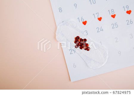 Menstruation calendar with daily sanitary pads on pink background. Woman critical days, woman hygiene protection concept Menstruation calendar with daily sanitary pads on pink background. Woman critical days, woman hygiene protection concept 67824975