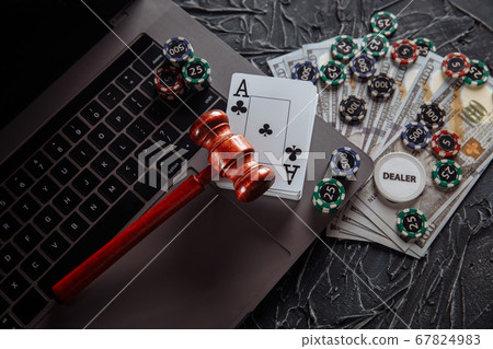 Judge wooden gavel, money banknotes and playing cards on computer keyboard, legal rules for online gambling concept Judge wooden gavel, money banknotes and playing cards on computer keyboard, legal rules for online gambling concept 67824983