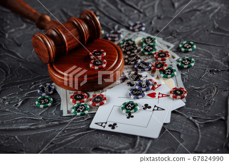 Online gambling and justice theme, cards, playing chips and judge gavel on old grey table Online gambling and justice theme, cards, playing chips and judge gavel on old grey table 67824990