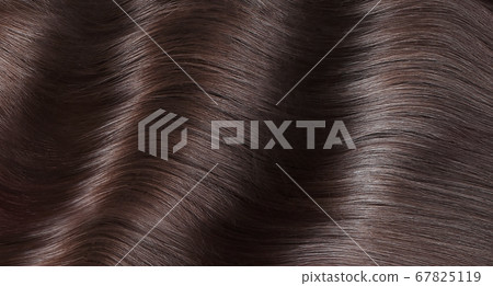 A closeup view of a bunch of shiny straight brown hair in a wavy curved style A closeup view of a bunch of shiny straight brown hair in a wavy curved style 67825119
