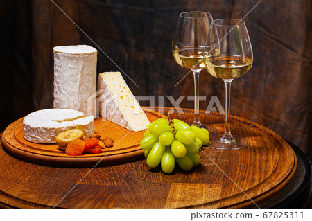 Cheese of elite variety sliced on a wooden board 67825311