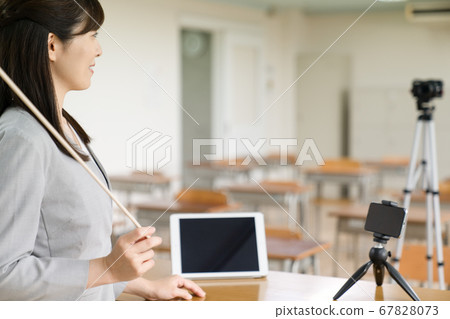 Teacher delivering online lessons Teacher delivering online lessons 67828073