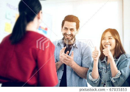 Happy group of business people clapping in office. Happy group of business people clapping in office. 67835853