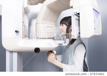A woman taking an X-ray A woman taking an X-ray 67835862