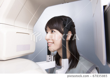 A woman taking an X-ray A woman taking an X-ray 67835865