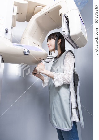 A woman taking an X-ray 67835867