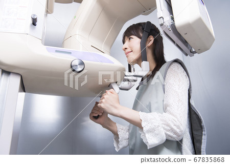 Woman taking X-ray of teeth Woman taking X-ray of teeth 67835868