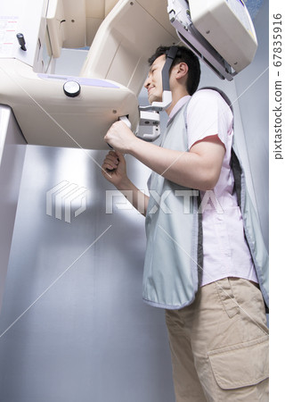 Men taking radiographs of teeth Men taking radiographs of teeth 67835916
