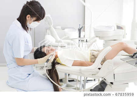 Girl treating teeth 67835959