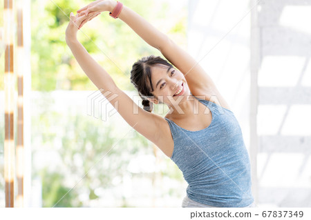 Young woman exercising outdoors Young woman exercising outdoors 67837349