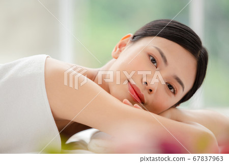 A woman relaxing with beauty treatment A woman relaxing with beauty treatment 67837963