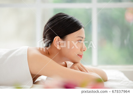 A woman relaxing with beauty treatment A woman relaxing with beauty treatment 67837964