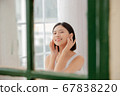 Woman doing skin care in her room 67838220