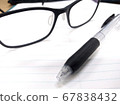 Glasses and ballpoint pen 67838432