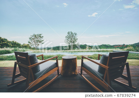 Two chairs for relaxing with deep green mountains Two chairs for relaxing with deep green mountains 67839274