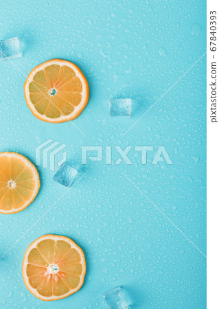 Slices of fresh orange on a blue background with 67840393