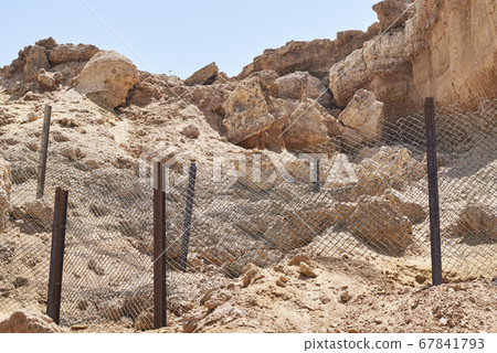 Rock collapse on the beach. Collapsed rock, 67841793