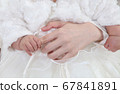 Baby's hand holding mom's finger 67841891
