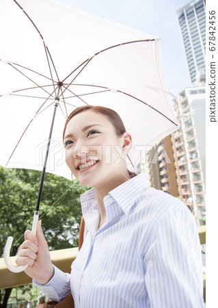 A woman holding a parasol 67842456