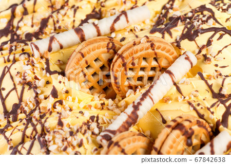 Oange ice-cream with cookies and chocolate glaze. 67842638