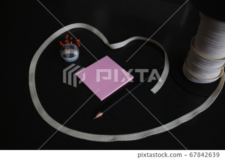 Set of tailoring tools and accessories on a black 67842639