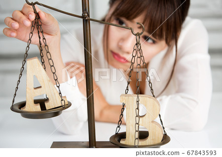 Woman comparing A and B 67843593