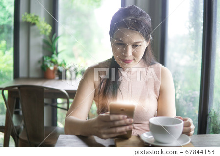 Portrait of Asian woman in the cafe with face recognition concept. Portrait of Asian woman in the cafe with face recognition concept. 67844153