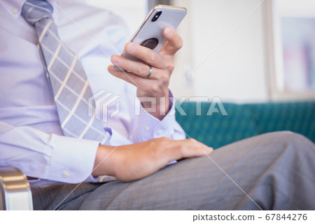 Businessman on a train 67844276