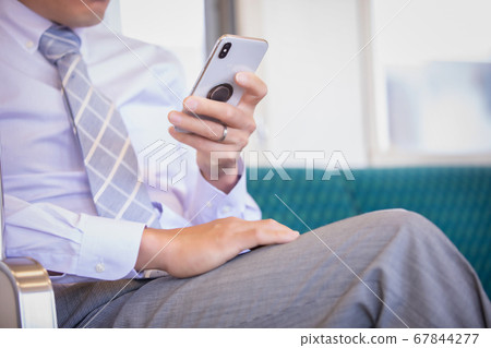 Businessman on a train 67844277
