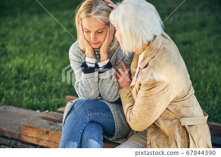 Adult woman is hugging her female friend 67844390