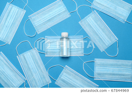 coronavirus COVID-19 pandemic concept - background made of antiviral surgical protective medical masks and alcohol hand sanitizer antiseptic for protection against corona virus coronavirus COVID-19 pandemic concept - background made of antiviral surgical protective medical masks and alcohol hand sanitizer antiseptic for protection against corona virus 67844969