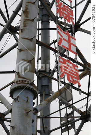 High-voltage tower over the riverbed of the Tama River High-voltage tower over the riverbed of the Tama River 67845028