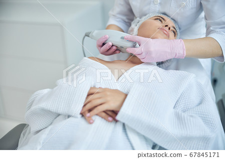 Calm attractive lady undergoing body lifting therapy Calm attractive lady undergoing body lifting therapy 67845171