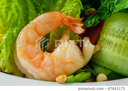 Macro photo of shrimp in salad with cucumber, arugula and pine nuts Macro photo of shrimp in salad with cucumber, arugula and pine nuts 67845173