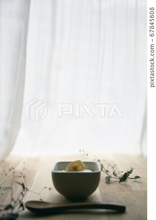 A window with natural light and a box with yogurt A window with natural light and a box with yogurt 67845608