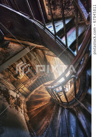 Spiral staircase in the old house 67845811