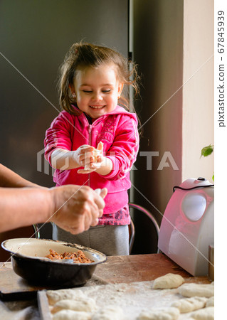 At home, granddaughter and grandmother cook At home, granddaughter and grandmother cook 67845939