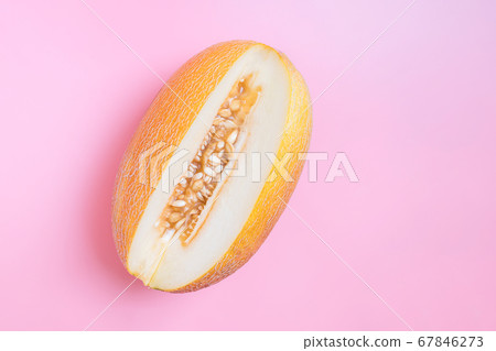 Melon half on orange background. Creative layout made of fresh melon. Flat lay, top view, copy space Melon half on orange background. Creative layout made of fresh melon. Flat lay, top view, copy space 67846273