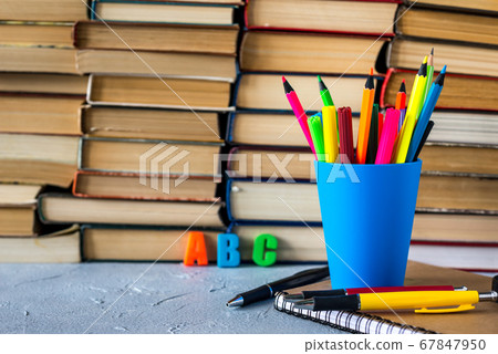 A stack of books and pencils on a desk in elementary school. A stack of colorful books. Education background. Business education concept. Copy space for text. A stack of books and pencils on a desk in elementary school. A stack of colorful books. Education background. Business education concept. Copy space for text. 67847950