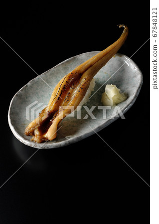 A handful of roasted conger eel served on a plate (black background) A handful of roasted conger eel served on a plate (black background) 67848121