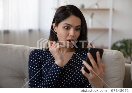 Shocked Vietnamese girl surprised by message on cellular 67848671