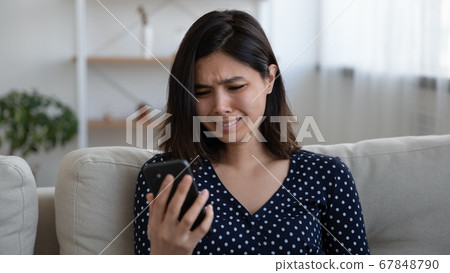 Unhappy Vietnamese girl distressed with cellphone message Unhappy Vietnamese girl distressed with cellphone message 67848790