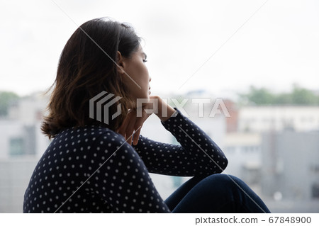 Upset millennial girl look in distance missing Upset millennial girl look in distance missing 67848900